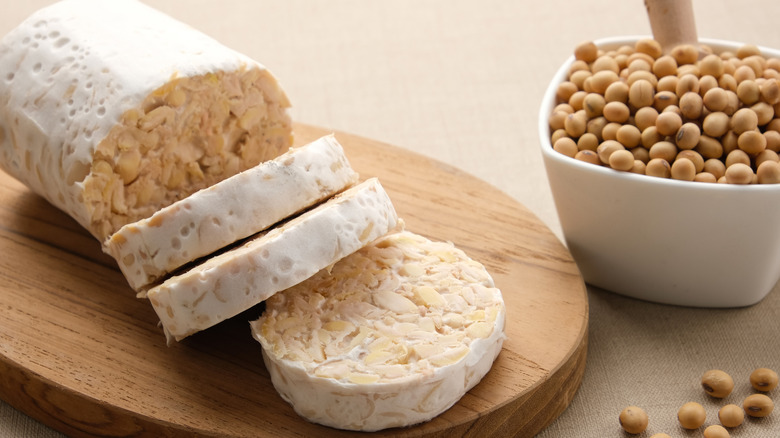 Raw tempeh on a chopping board
