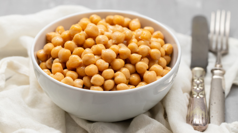 Chickpeas in white bowl closeup.