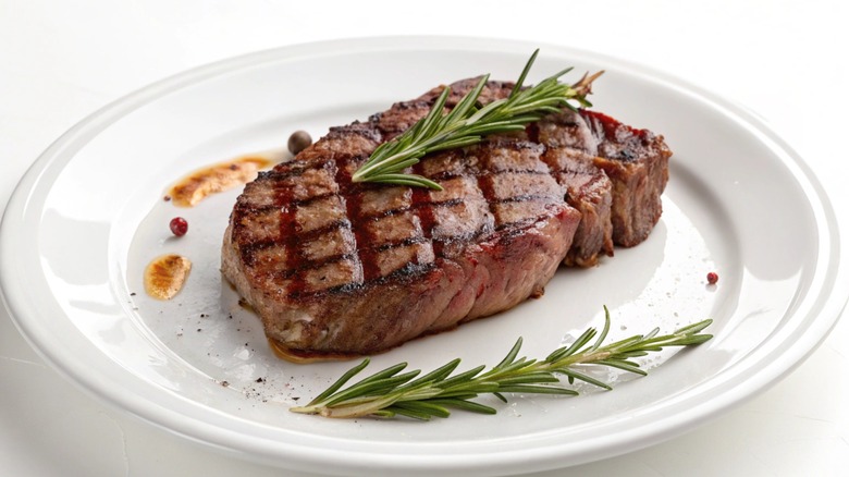steak with rosemary sprigs