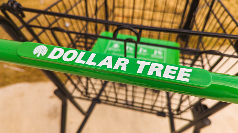 A close-up of the handle of a Dollar Tree shopping cart