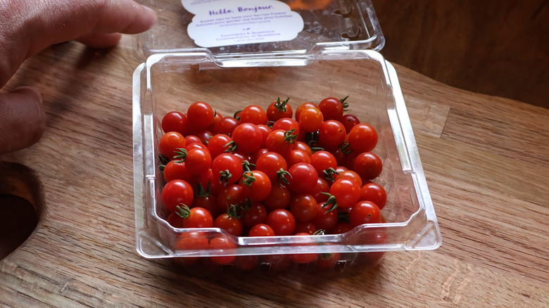 spoon tomatoes in open plastic clamshell container