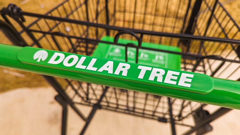 A close-up of the handle on a Dollar Tree shopping cart