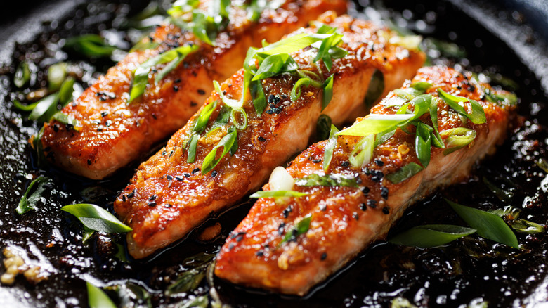 Teriyaki salmon filets dressed with chopped scallions.