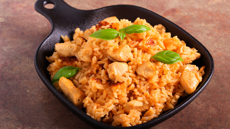 Chicken and rice casserole in cast iron dish.