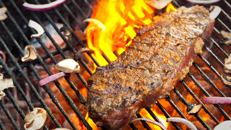 new york strip steak on a charcoal grill
