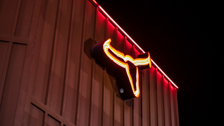 LongHorn steakhouse logo lit up at night.