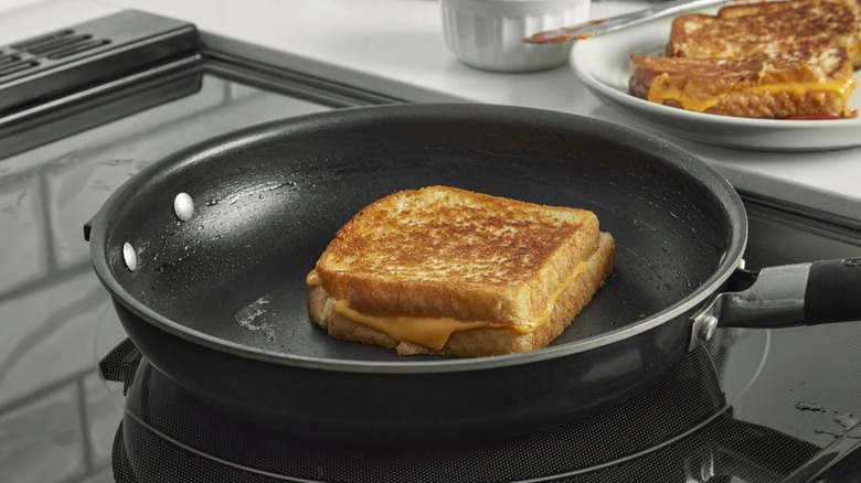 grilled cheese being cooked in skillet
