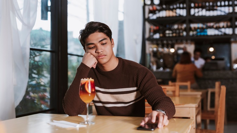 disappointed man with cocktail