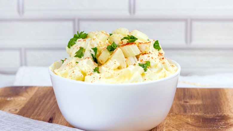 bowl of potato salad with herbs