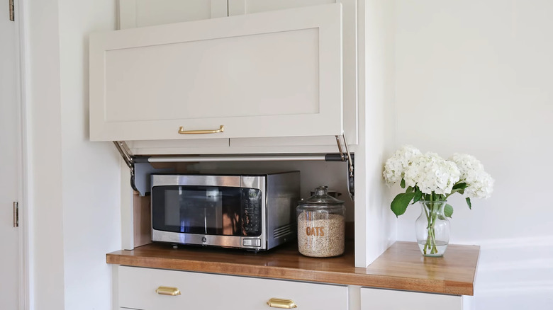 An air fryer, toaster, coffee maker, and blender all next to each other on a kitchen counter
