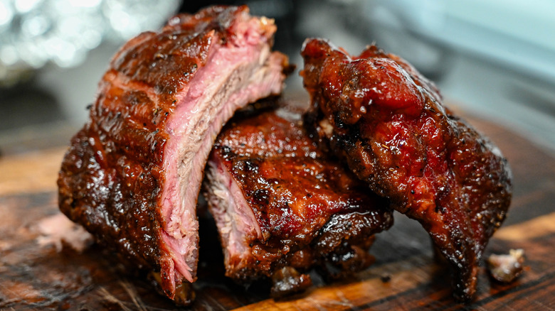 Juicy-looking cut ribs piled on cutting board