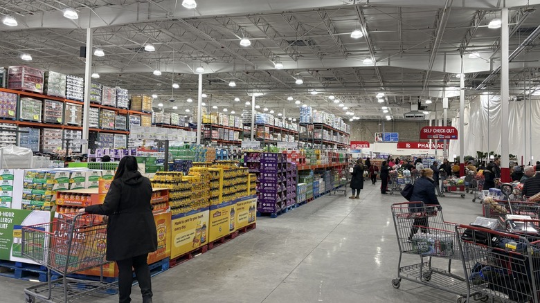 costco shoppers push carts inside warehouse