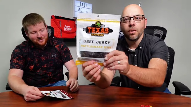 man holds a package of texas roadhouse beef jerky