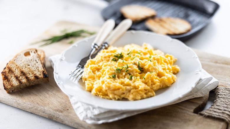 plate of scrambled eggs and toasted bread
