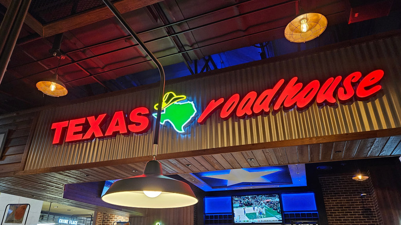 Interior view of Texas Roadhouse with illuminated sign.