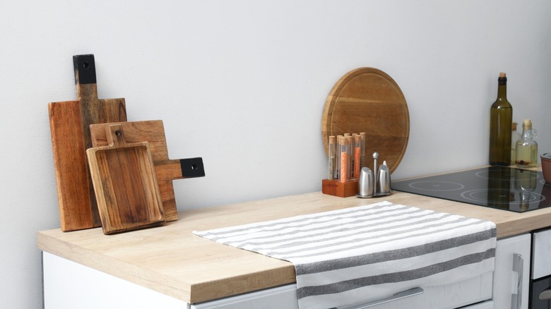 multiple wooden cutting boards sit on a counter