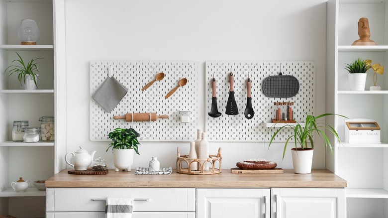 kitchen peg board with utensils and tools