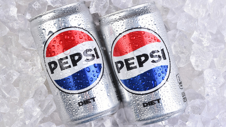 Two mini cans of Diet Pepsi on a bed of ice