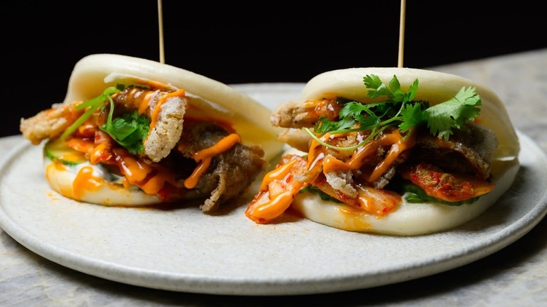 Two kimchi baos on white plate, from Planta restaurant.
