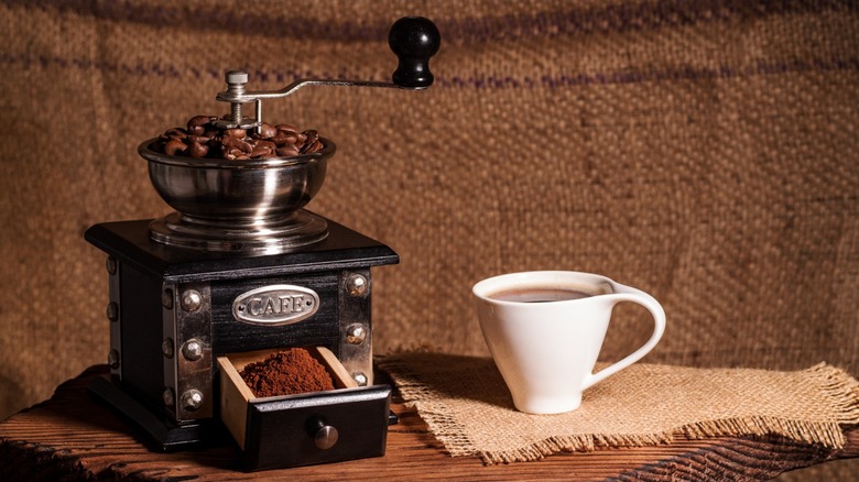 vintage-style coffee mill with hand crank and drawer