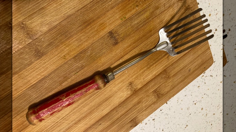 A Foley fork on a chopping board