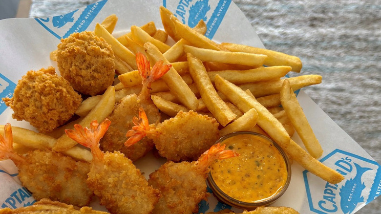 Fried fish and shrimp on Captain D's-branded paper.