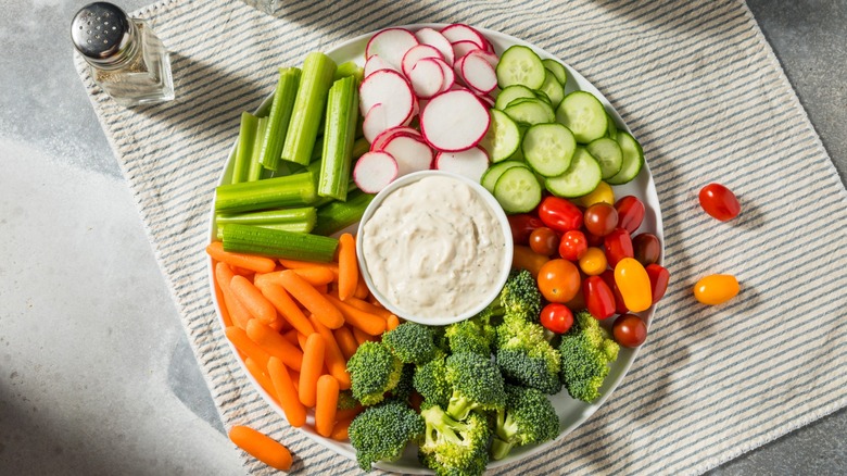 veggie tray with dip in the middle