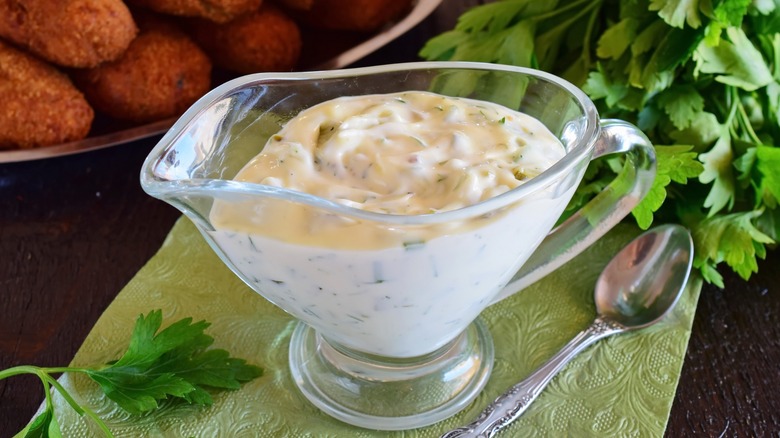 tartar sauce in gravy boat with spoon