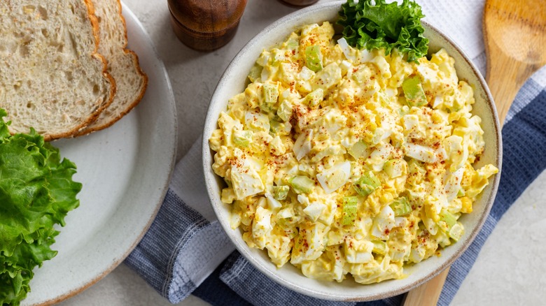egg salad with sandwich fixings and spoon