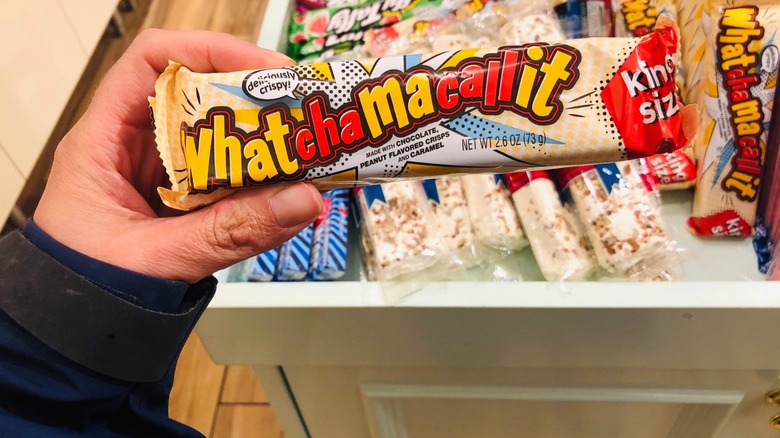 a hand holds a whatchamacallit bar