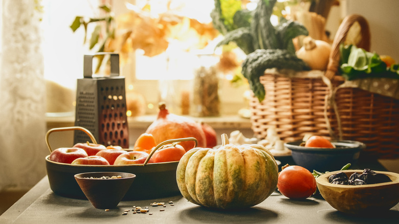 Basket with autumn produce in home.