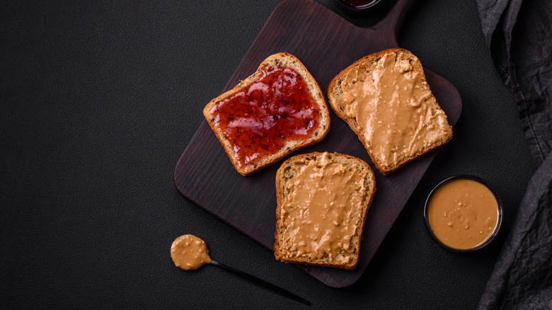 sandwich slices are spread with peanut butter and jelly