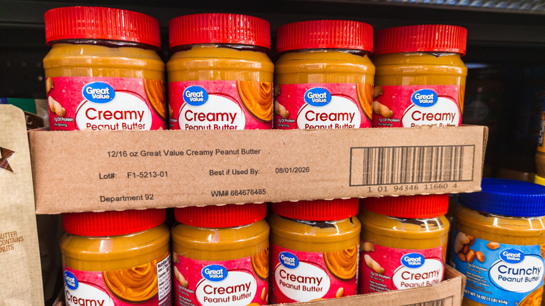 Jars of Walmart's Great Value brand peanut butter on the shelf
