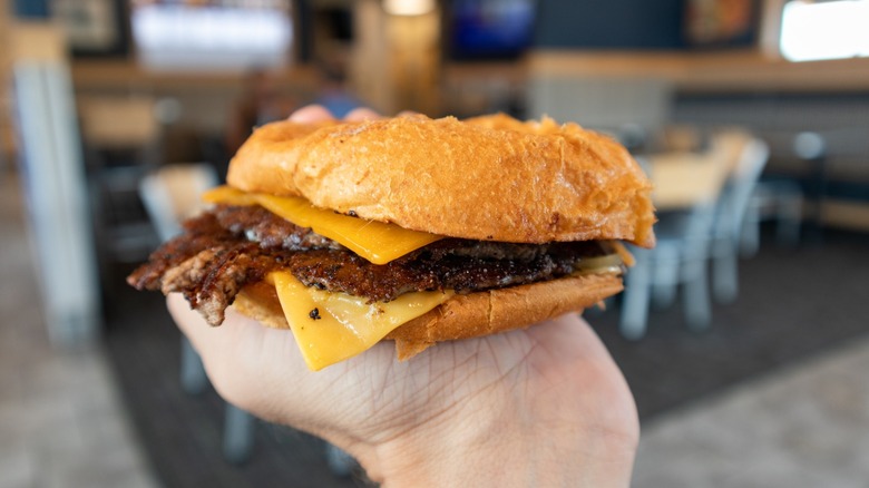 a hand holds a culver's butter burger