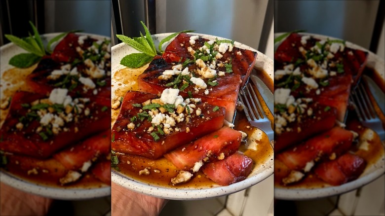 roasted watermelon "steaks" on a platter with dressing