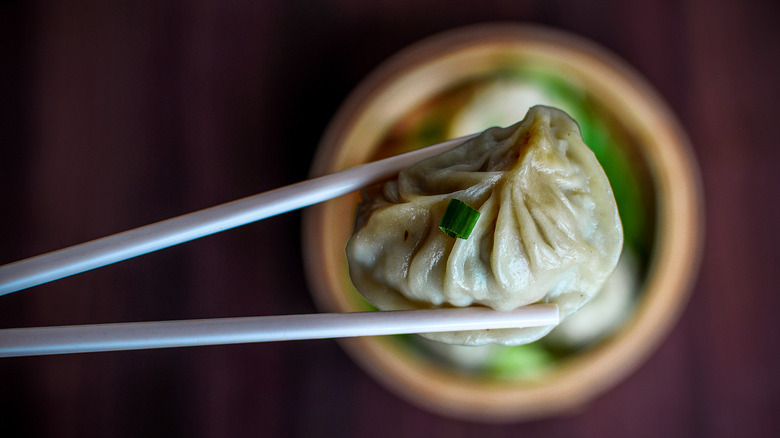 Dumpling held with chopsticks