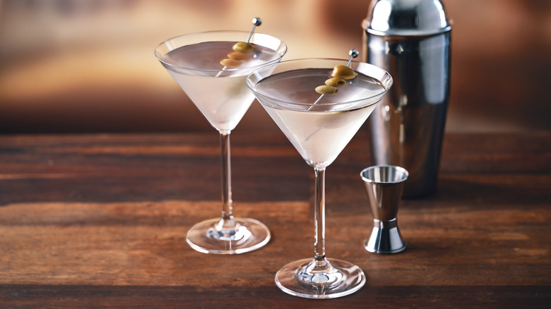 Two vodka martinia with olive skewers