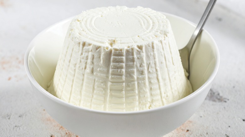 molded ricotta cheese in white bowl