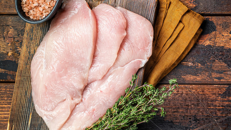 Raw chicken cutlets  on a wooden board