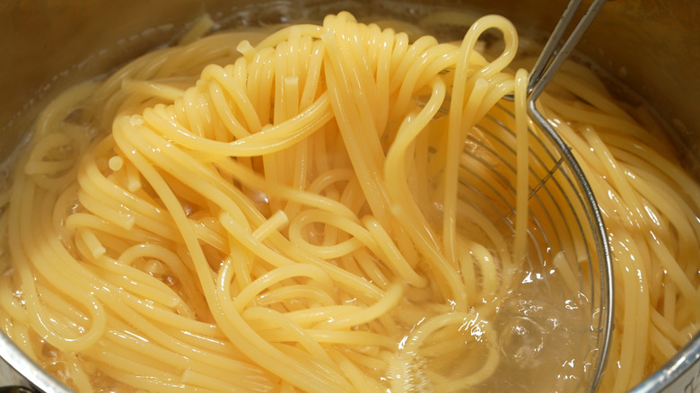 Close-up of spaghetti cooking in a pan