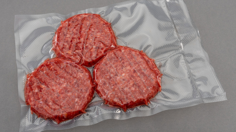 Vacuum sealed raw burger patties.