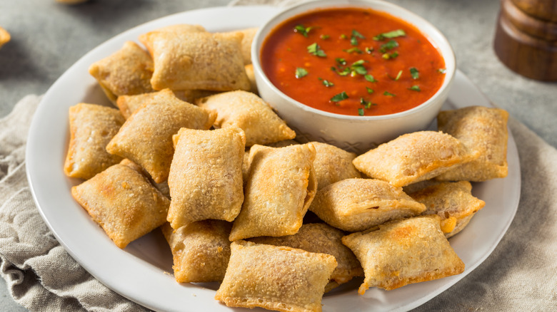homemade pizza rolls with sauce on white plate