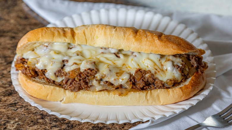 gooey cheesesteak sandwich on plate