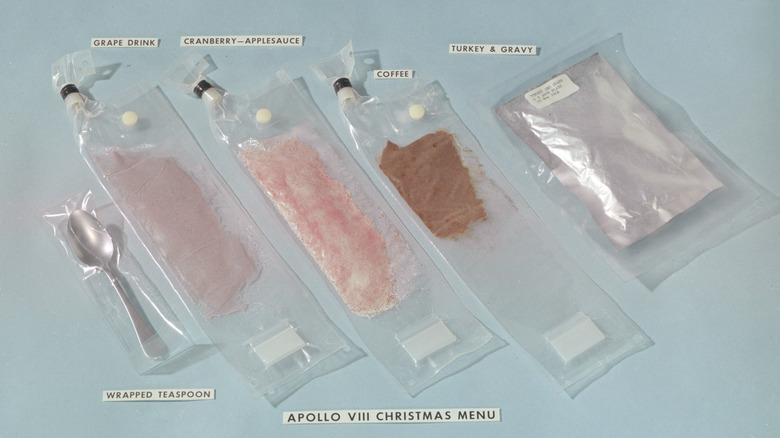 Apollo 8 christmas menu laid out in pouches on blue background