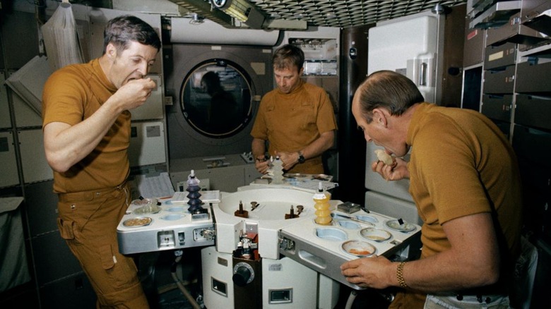 Skylab astronauts eating in space