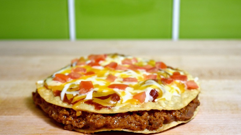 taco bell mexican pizza against green background