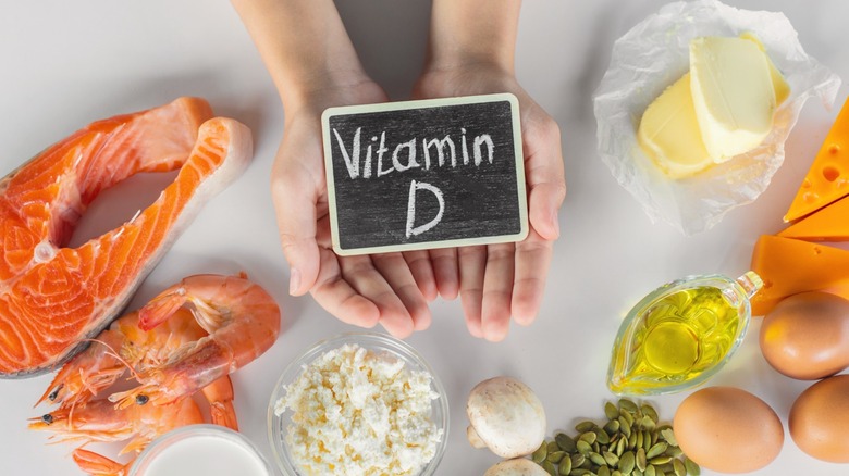 hands surrounded by high vitamin d foods