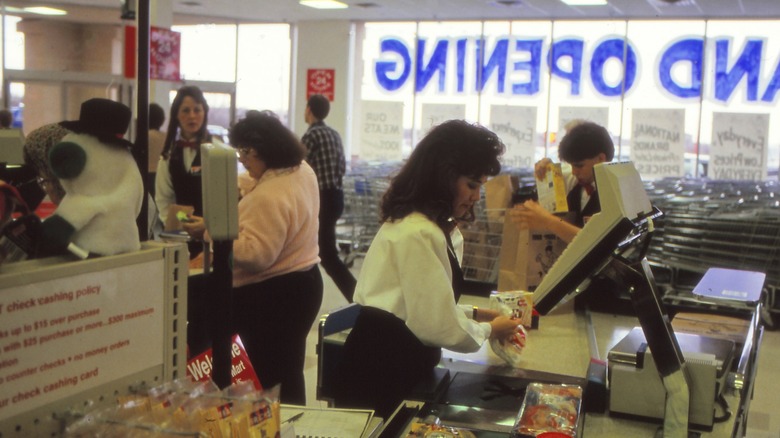 busy checkout area at an american 1980s supermarket