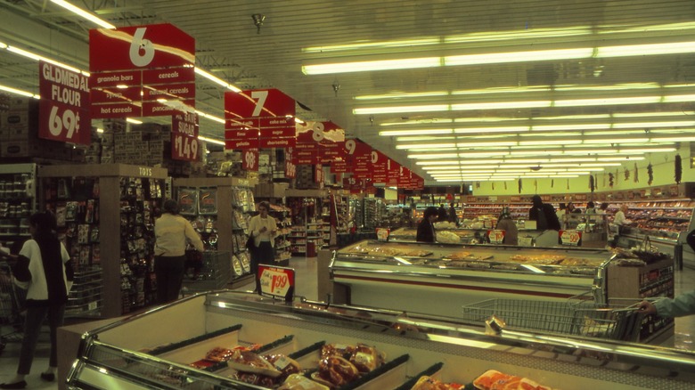 yellowish lights over a 1980s grocery store