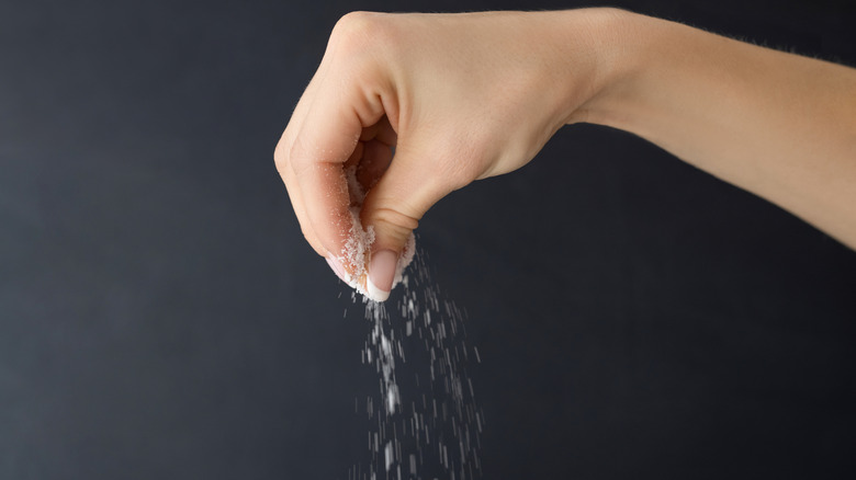Hand sprinkling salt